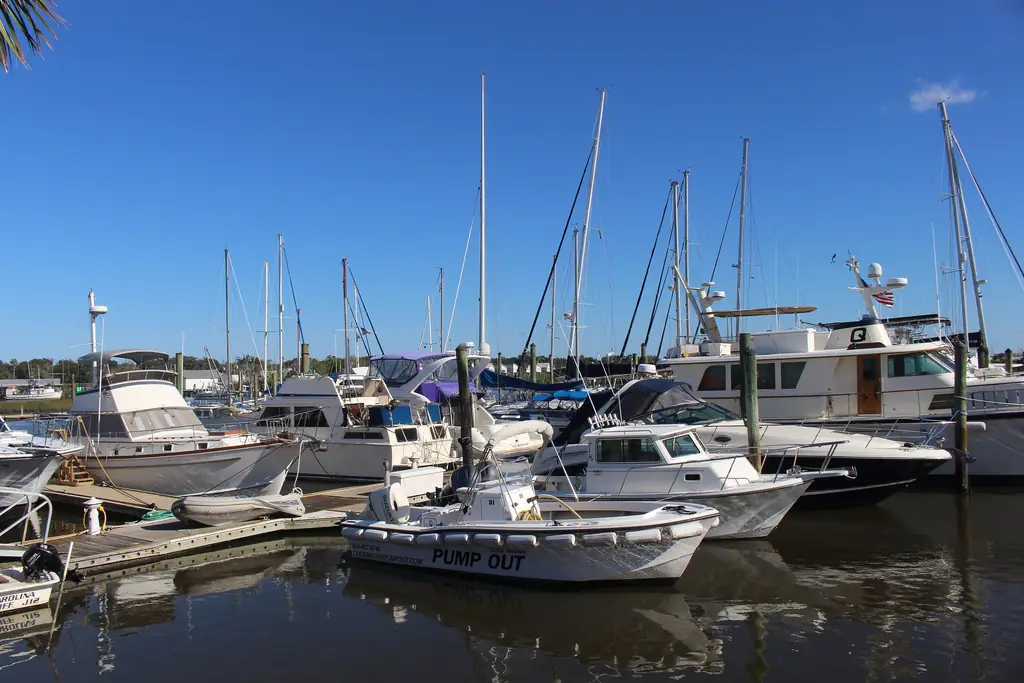 Boats tied to fixed docks and pilings at a marina on the San Sebastian River in St. Augustine